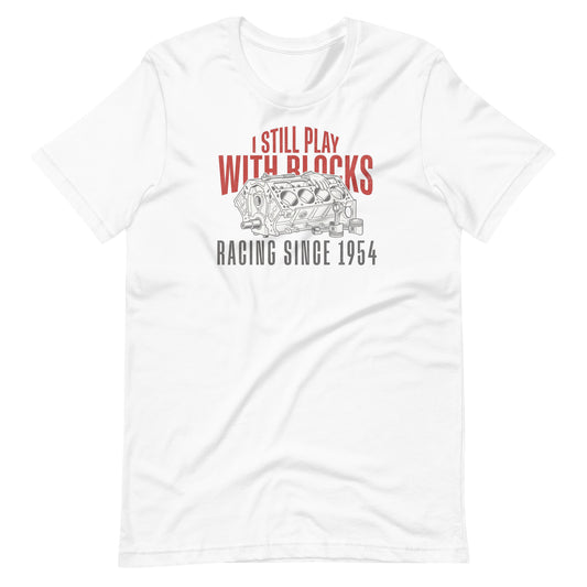 I Still Play With Blocks Tee, White front view — bare V8 block line art with slogan print, Marque automotive apparel