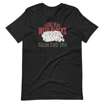 I Still Play With Blocks Tee, Black Heather front view — bare V8 block line art with slogan print, Marque automotive apparel