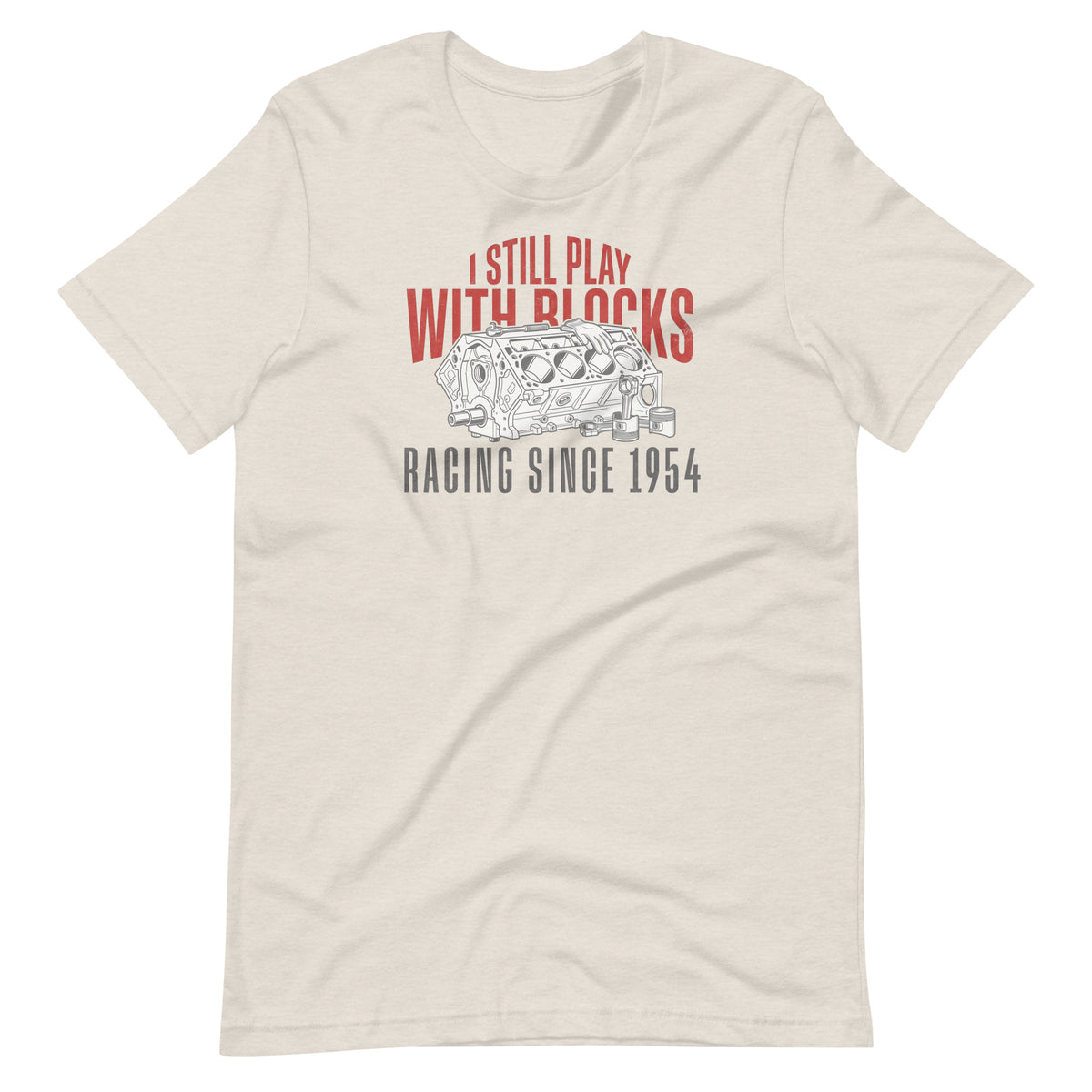 I Still Play With Blocks Tee, Heather Dust front view — bare V8 block line art with slogan print, Marque automotive apparel