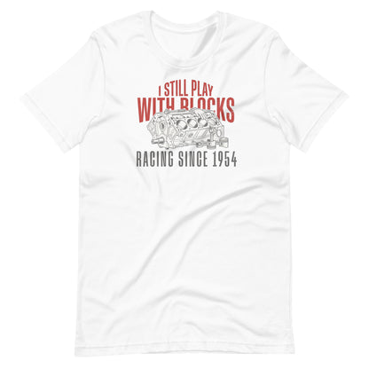 I Still Play With Blocks Tee, White front view — bare V8 block line art with slogan print, Marque automotive apparel